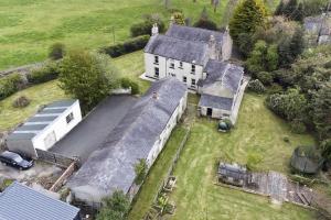 an aerial view of an old house with a barn at Annsborough House Castlewellan in Castlewellan