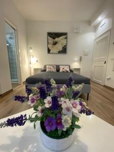 a bedroom with a bed with purple and white flowers at Garden City House in Rome