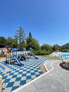 a playground with a slide and a pool at BAYKA - SPA resort in Kosiv