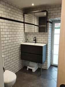 a bathroom with a sink and a toilet and a mirror at 35 min Disney - Paris - Family room at homestay with bathtub and dining - lounge area - secure parking - 5 people and 1 baby - duplex with independent entrance on 1rst floor at inhabitant's house in Coupru