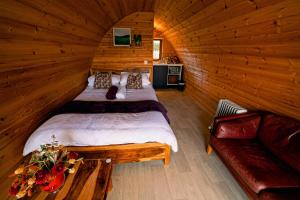 a bedroom with two beds in a log cabin at Causeway Country Pods in Bushmills