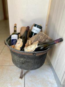 a basket filled with bottles of wine sitting next to a wall at L'Olivo - 1932 in Controguerra