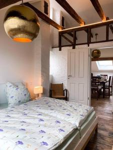 a bedroom with a bed and a dining room at Ferienwohnungen Alte Destillerie in Neuwied +28 photos