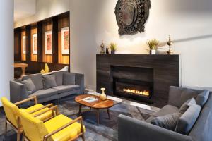 a living room with couches and a fireplace at Le Méridien Columbus, The Joseph in Columbus