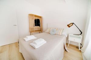 ein Schlafzimmer mit einem Bett mit zwei Handtüchern darauf in der Unterkunft Esplendido apartamento en el centro in Málaga