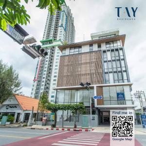 a tall building on a city street with at Tay Residence in Bangkok