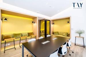 a conference room with a table and a couch at Tay Residence in Bangkok +23 photos
