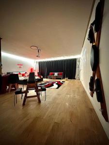 a living room with a table and a dining room at Love Room 80m2 BDSM 50 nuances de Grey - SAUNA - Parking gratuit in Antibes