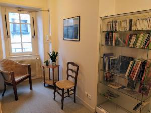 a room with a book shelf filled with books at Hôtel restaurant Notre Dame in Orcival