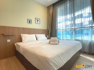 a bedroom with a large bed with a large window at The Wave Suites Melaka by BEESTAY in Melaka