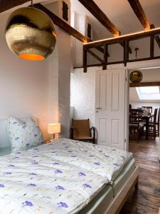 a bedroom with a bed and a dining room at Ferienwohnungen Alte Destillerie in Neuwied