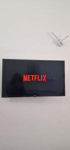 a television with a netflix sign on a wall at La Perla di Ele in Bari