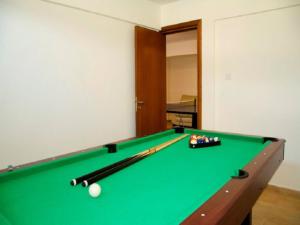 a green pool table with balls on top of it at Villa Saraliana Sandy Beach Villas - Heated Pool - Jacuzzi - Private Beach Area in Polis Chrysochous