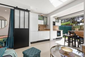 a kitchen and living room with a glass table at CAP eureka SUN in Cap d'Agde