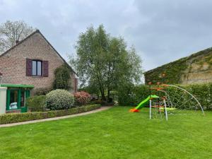 a yard with a playground in a house at La ferme du paradis in Merris