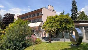 a large metal sculpture in front of a building at Hotel Monte Verità in Ascona