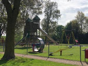 a playground with a slide in a park at IJsselmeer appartement in Andijk