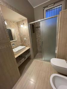 a bathroom with a shower and a toilet and a sink at Casa della Luna in Bari