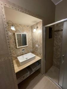 a bathroom with a sink and a shower at Casa della Luna in Bari