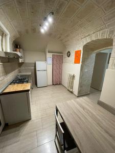 a large kitchen with a stove and a refrigerator at Casa della Luna in Bari