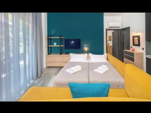 a bedroom with a bed with two towels on it at LUNAR in Skala Rachoniou