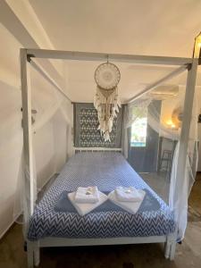a bed in a room with two towels on it at Chez Cécile Home in Mochlos