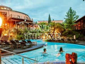 a pool at a hotel with people in the water at Stay aWhile Apartment 5 Min zum GOP, BALI-Therme, HDZ & Klinik Nähe, Netflix in Bad Oeynhausen