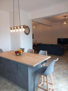 a kitchen with a table with a bowl of fruit on it at Aurora Andros House in Korthi