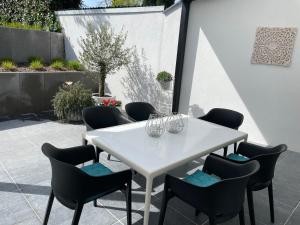 een witte tafel en stoelen op een patio bij Vakantiewoningen Bienvenue, Le Pont in Lanaken