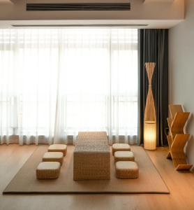 a room with four stools in front of a window at JI HOTEL 