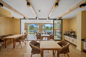 a restaurant with tables and chairs and a patio at ZEYT INN HOTEL in Datca