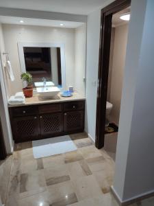 a bathroom with a sink and a mirror at Villa Kenais Sunset in Taguermess +21 photos