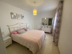 a bedroom with a large bed and a mirror at Céntrico in Antequera +16 photos