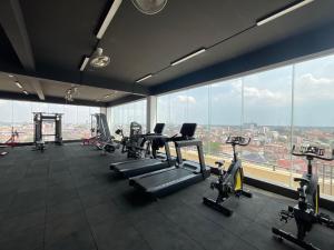 a gym with cardio machines and a large window at JI HOTEL 