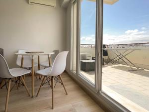 a room with a table and chairs and a balcony at California Park - Wifi, AC, 4 pers in Nice