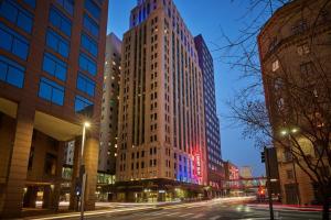 a tall building on a city street at night at Renaissance Saint Elm Dallas Downtown Hotel in Dallas