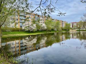 a view of a river with buildings in the background at RONY apartment in Liepāja