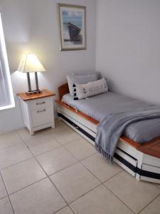a bedroom with a bed and a lamp on a table at Home from Home 5 bedroom villa in Davenport