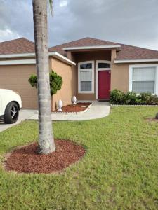 a palm tree in front of a house at Home from Home 5 bedroom villa in Davenport