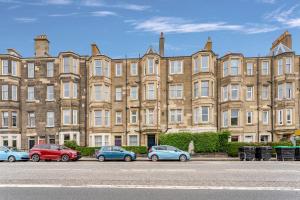 a large building with cars parked in front of it at spacious flat, close to the city centre with scenic views in Edinburgh