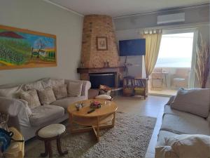 a living room with a couch and a table at Indigo in Rafina