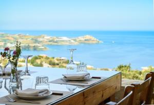 a table with a view of the ocean at Spiros-Soula Thematic Suites in Agia Pelagia