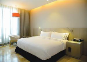 Postel nebo postele na pokoji v ubytování GHL Hotel Monteria
