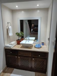 a bathroom with a sink and a mirror at Villa Kenais Sunset in Taguermess