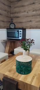 a table with a microwave and flowers on top of it at Holiday Home Old Town in Sarajevo