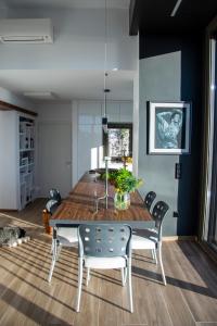 a dining room with a wooden table and chairs at The Boatyard Luxury Villa in Tzíkidhes