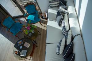an overhead view of a couch with pillows and a table at The Boatyard Luxury Villa in Tzíkidhes