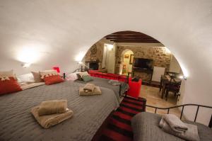 a bedroom with a large bed and a living room at Villa Malevi Dimitsana in Dimitsana