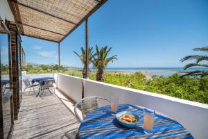 a table with a bowl of food on a balcony at Milos Alexandra Studio in Frangokastello