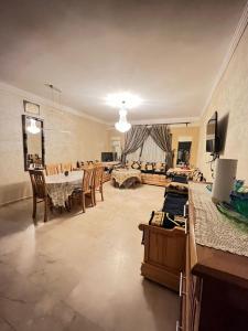 a large living room with a table and chairs at Marina Agadir Appartement in Agadir